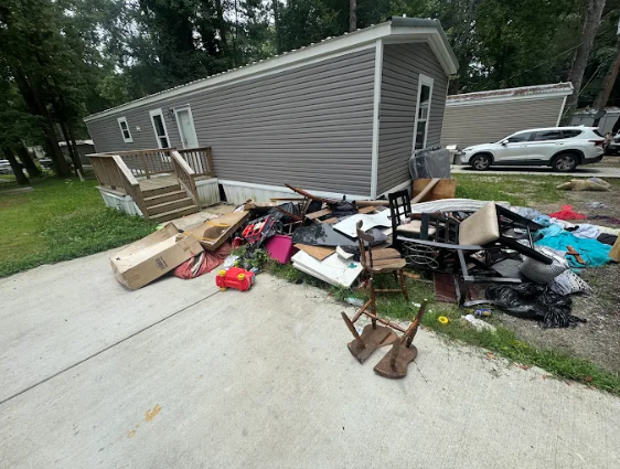 Furniture, boxes and clutter piled outside a home before removal