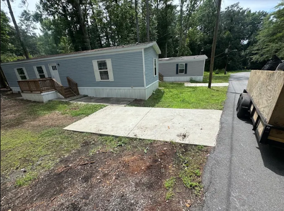 The same driveway swept clear after Big Kountry hauled the items away